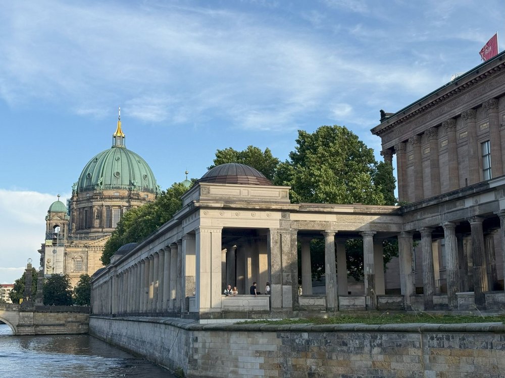 Eine Ansicht der Berliner Museumsinsel mit dem Berliner Dom im Hintergrund, aufgenommen von der Spree aus während einer Schifffahrt.
